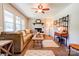 Comfortable living room featuring fireplace, ceiling fan, and large windows at 701 Mcswain Rd, Shelby, NC 28150
