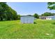 Metal storage shed surrounded by lush green lawn and mature trees at 701 Mcswain Rd, Shelby, NC 28150