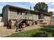 Exterior view of home with a deck, stairs, grill, and gravel area in the backyard at 7010 Executive Cir, Denver, NC 28037
