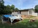 Exterior showing a deck, above ground pool and gravel area in the backyard at 7010 Executive Cir, Denver, NC 28037