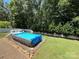 Backyard featuring an above-ground pool with a deck that creates a private space for relaxation at 7010 Executive Cir, Denver, NC 28037