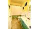 Bathroom featuring a green vanity, tiled floors, and a shower curtain, creating a cozy atmosphere at 7010 Executive Cir, Denver, NC 28037