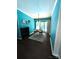 A dining room with hardwood floors, teal colored walls, and a chandelier at 7010 Executive Cir, Denver, NC 28037
