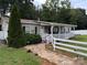 Charming home featuring a welcoming front porch, stone walkway, and a well-manicured lawn at 7010 Executive Cir, Denver, NC 28037