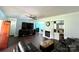 Open living room featuring a ceiling fan, dark wood floors, and a fireplace at 7010 Executive Cir, Denver, NC 28037