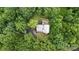An aerial view showcasing this beautiful home set amidst a tranquil and heavily wooded landscape at 720 Potneck Rd, Salisbury, NC 28147
