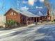 Charming cabin-style home with a metal roof, a cozy porch, and a well-maintained driveway surrounded by nature at 720 Potneck Rd, Salisbury, NC 28147