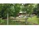 Secluded backyard featuring a patio, lush landscaping, and mature trees offering privacy and serenity at 720 Potneck Rd, Salisbury, NC 28147