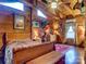 Spacious log cabin bedroom with a ceiling fan and rustic decor at 720 Potneck Rd, Salisbury, NC 28147