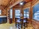 Cozy dining area with a table and seating near large windows, featuring rustic wood decor at 720 Potneck Rd, Salisbury, NC 28147