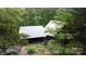 Charming log home with a metal roof, front porch, and lush greenery surrounding the property at 720 Potneck Rd, Salisbury, NC 28147