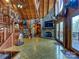Expansive living room with floor-to-ceiling windows, stone fireplace, and spiral staircase at 720 Potneck Rd, Salisbury, NC 28147