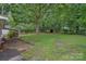 Spacious backyard featuring a shed, mature trees and green lawn at 807 Claremont Rd, Charlotte, NC 28214