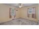 A bedroom with neutral decor, carpet, and two windows offering a bright and simple living space at 807 Claremont Rd, Charlotte, NC 28214