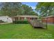 Charming single-story brick home with a well-maintained front lawn and handicap accessible ramp at 807 Claremont Rd, Charlotte, NC 28214