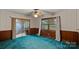 Room with blue carpet and wallpaper, providing a vintage aesthetic with a sliding glass door at 807 Claremont Rd, Charlotte, NC 28214