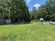 Large, grassy backyard with a playground, swing set, and plenty of space for recreation at 8122 Hutchison Ln, Vale, NC 28168