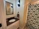 Traditional bathroom vanity with granite countertop, decorative mirror and shower with patterned curtain at 8122 Hutchison Ln, Vale, NC 28168