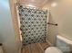 Bathroom features a shower with a patterned curtain and a standard toilet at 8122 Hutchison Ln, Vale, NC 28168