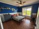 A cozy bedroom with blue walls, a window overlooking the outside, and modern decor at 8122 Hutchison Ln, Vale, NC 28168