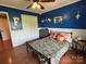 Bedroom with blue accent wall, closet and a view to the outdoor nature at 8122 Hutchison Ln, Vale, NC 28168