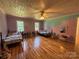 Large bedroom with hardwood floors, ceiling fan, and two beds with colorful decor at 8122 Hutchison Ln, Vale, NC 28168