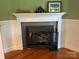 A close-up view of the fireplace with decorative mantel and stone surround at 8122 Hutchison Ln, Vale, NC 28168