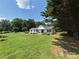 Landscaped front yard of a well-maintained ranch home with a picturesque setting at 8122 Hutchison Ln, Vale, NC 28168