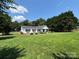 Single-story home on a large lot featuring mature trees and a well-manicured lawn at 8122 Hutchison Ln, Vale, NC 28168