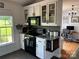 Stylish kitchen with modern appliances and ample cabinet space, adjacent to a functional home office at 8122 Hutchison Ln, Vale, NC 28168