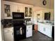 A kitchen with a black stove, white cabinets, and a gray countertop at 8122 Hutchison Ln, Vale, NC 28168