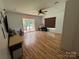 Large room with hardwood floors, lots of natural light from door to covered patio at 8122 Hutchison Ln, Vale, NC 28168
