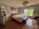 Primary bedroom with hardwood floors, crown molding, American flag art and a view of the back yard at 8122 Hutchison Ln, Vale, NC 28168