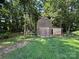 Rustic wooden shed surrounded by trees, providing extra storage and a charming touch at 8122 Hutchison Ln, Vale, NC 28168
