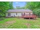A view of home's backyard, deck, and lush surrounding trees at 9000 Vagabond Rd, Charlotte, NC 28227