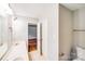 Bathroom boasts a white vanity, ceramic tile floor, and open doorway to bedroom at 9000 Vagabond Rd, Charlotte, NC 28227