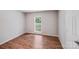 Bedroom with hardwood floors and a large window overlooking the backyard at 9000 Vagabond Rd, Charlotte, NC 28227