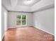 Bright bedroom features hardwood floors, two windows, and modern ceiling at 9000 Vagabond Rd, Charlotte, NC 28227