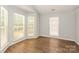 Bright bedroom with wood-look flooring, neutral walls, and large windows offering natural light at 9000 Vagabond Rd, Charlotte, NC 28227