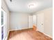 Bedroom with hardwood floors, window and doorways to bathroom and closet at 9000 Vagabond Rd, Charlotte, NC 28227