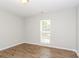 Bright bedroom features wood-look floors and a window letting in plenty of natural light at 9000 Vagabond Rd, Charlotte, NC 28227