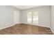 Comfortable bedroom with natural light, light walls, and wood-look flooring at 9000 Vagabond Rd, Charlotte, NC 28227