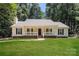 Charming home features covered porch, black shutters, and lush green lawn at 9000 Vagabond Rd, Charlotte, NC 28227