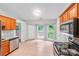 The kitchen has stainless steel appliances, granite counters and a view to the back yard and deck at 9000 Vagabond Rd, Charlotte, NC 28227