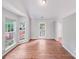 Bright living room with lots of natural light, wood-look flooring and door leading to the backyard at 9000 Vagabond Rd, Charlotte, NC 28227
