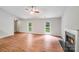 Living room features vaulted ceilings, wood-look flooring, a fireplace, and abundant natural light at 9000 Vagabond Rd, Charlotte, NC 28227