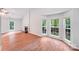 Bright living room with a cozy fireplace and a bay window showcasing the backyard at 9000 Vagabond Rd, Charlotte, NC 28227