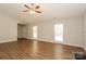 Open living room with light walls, wood-look flooring, and natural light from windows at 9000 Vagabond Rd, Charlotte, NC 28227