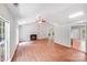 Bright living room with fireplace, wood-look flooring, neutral paint and lots of natural light at 9000 Vagabond Rd, Charlotte, NC 28227