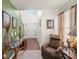 Bright foyer with hardwood floors, neutral walls, decorative table, and cozy armchair at 9511 Turning Wheel Dr, Charlotte, NC 28214